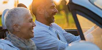 couple driving convertible