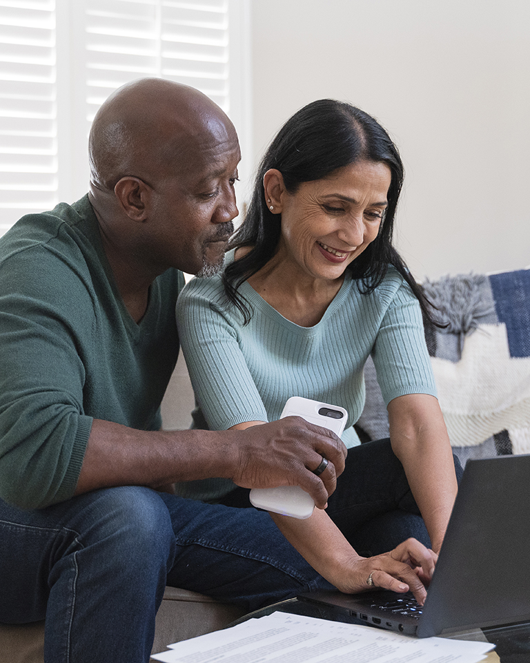 A couple looking up something on a laptop